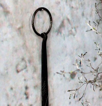 Bild av antiksvart ljusstake med metallring och kvistar