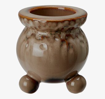 Bild på brunmelerad ljusstake med rundade former och glans