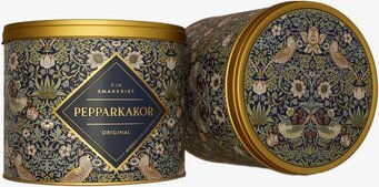 Bild på rund plåtburk med botaniskt mönster och fåglar