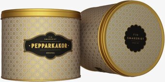 Bild på stilrena plåtburkar med geometriskt mönster och guld