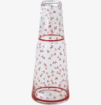 Bild på färgglad karaff och glas med prickigt mönster