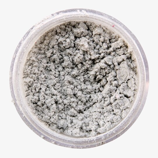 Bild av skimrande silverpulver i genomskinlig burk