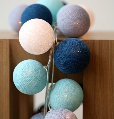 Bild av ljusslinga med globformade lampor i blå toner