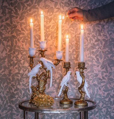 Foto: Antikguldfärgad ljusstake med vita fåglar