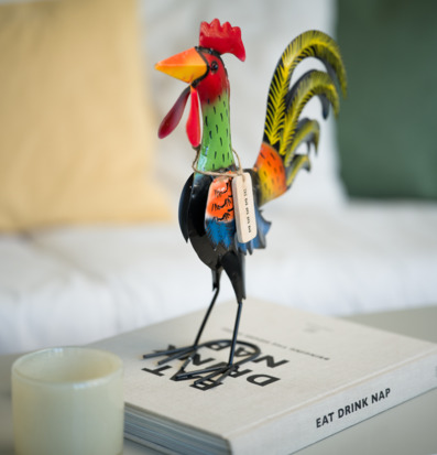 Foto: Färgstark tuppfigur i hamrad plåt på bokbordet