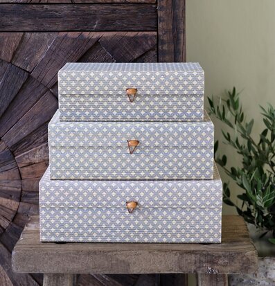 Bild: Staplade mönstrade förvaringsaskar i trä miljö