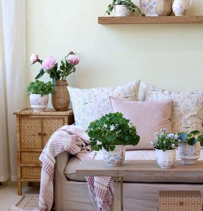 Bild av lugnt vardagsrum med blomkrukor och växter