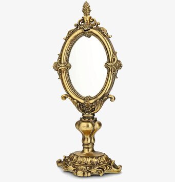 Foto: Oval spegel på fot med ornamenterad guldram