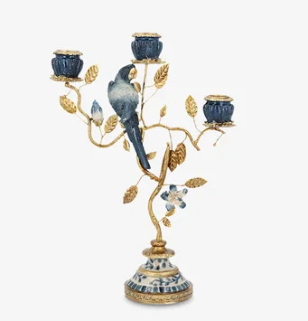 Foto: Blå och guld ljusstake med fågel och bladmotiv