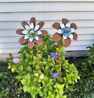 Foto: Två metallblommor med glaskulor i rabatt