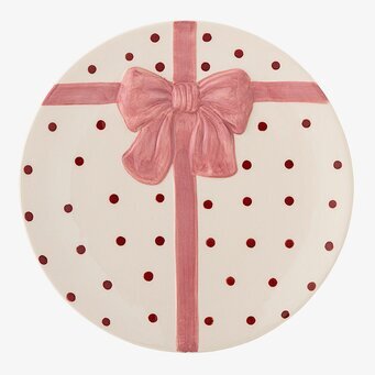 Foto: Prickig tallrik med rosa band och rosett motiv