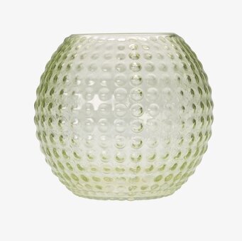 Bild av en grön ljuslykta med unik och uttrycksfull design