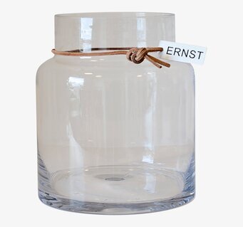 Foto av elegant glasvas med lädersnöre och etikett