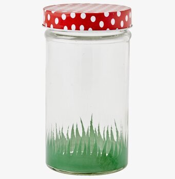 Bild av glasburk med färgglatt lock och grönt mönster
