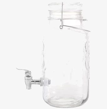 Foto av stilren glasburk med kran och handtag