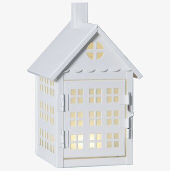 Bild av dekorativt vitt metallhus med ljusinsläpp