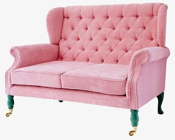 Bild av elegant rosa sammetsoffa med gröna ben
