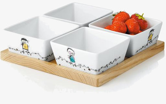 Bild av stilrena skålar med lekfull design och träbricka