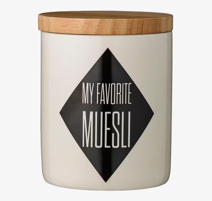 Bild av stilren porslinsburk med trälock i köket