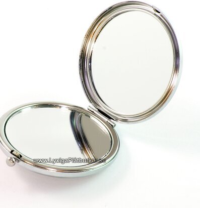 Foto av elegant fickspegel med dubbla spegelytor