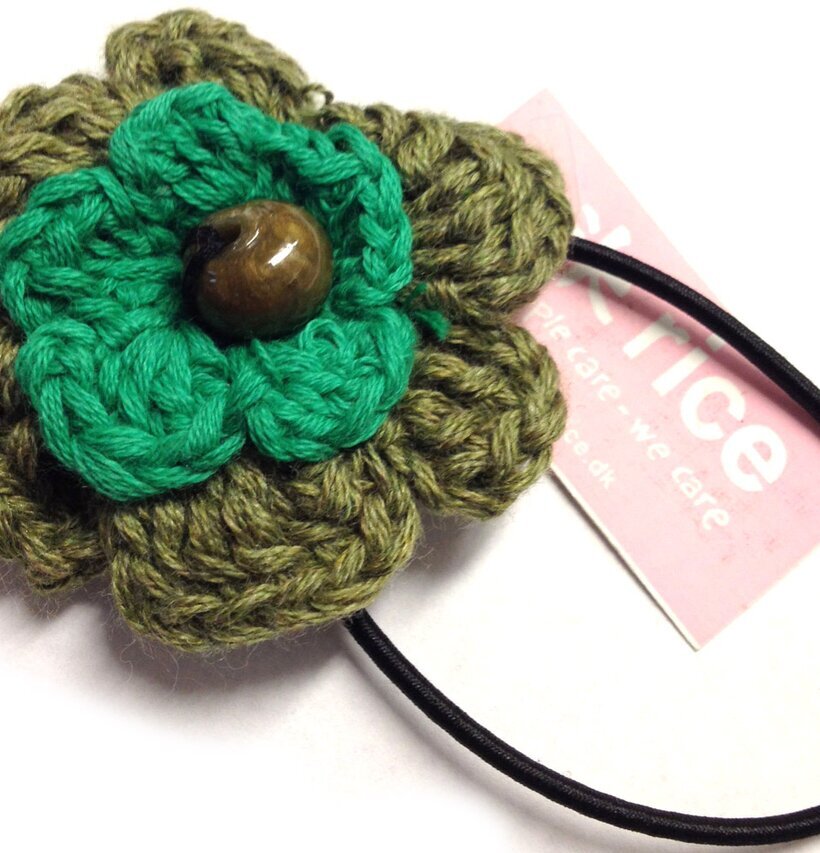 Foto av elegant hårsnodd med blomdesign i gröna nyanser