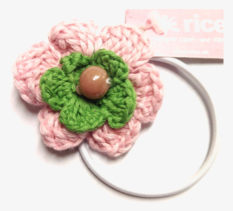 Bild av unik hårsnodd med blomdesign i rosa och grönt