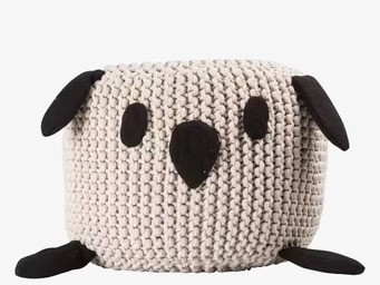 Bild av rund sittpuff med kaninmotiv i beige nyans