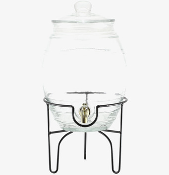 Foto av stilren glasburk med kran på elegant ställning