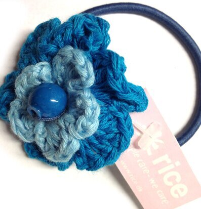 Bild av detaljrik hårsnodd med blå och turkos blomma