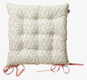 Bild av sittdyna med färgglada prickar och rosa band