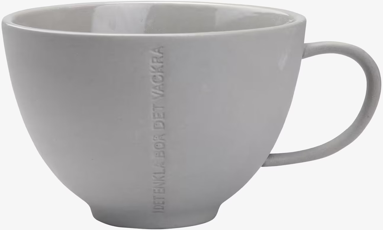 Bild av stilren tekopp i grått stengods med text