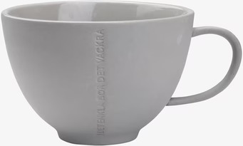 Bild av stilren tekopp i grått stengods med text